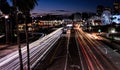 Drone shot of an asphalt road in a city at night with long exposure lights on it Royalty Free Stock Photo