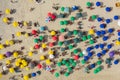 Drone shot of beach goers under umbrellas on the beach