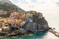 Drone shot of boats on the surface of the sea near Vernazza town on a rocky hill in Italy