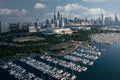 Drone shot of the Burnham Harbor full of parked boats with the beautiful cityscape of Chicago, USA