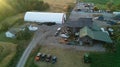 A drone shot of a farmhouse, farm fields and Barns