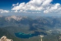 Drone shot of a lake in mountain landscape under blue cloudy sky Royalty Free Stock Photo