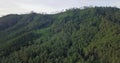 Drone shot of lush greened mountains with trees