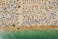 Drone shot of many people enjoying the beach and the ocean in high season- vacation pattern Royalty Free Stock Photo