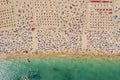 Drone shot of many people enjoying the beach and the ocean in high season- vacation pattern Royalty Free Stock Photo