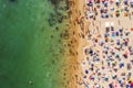 Drone shot of many people enjoying the beach and the ocean in high season- vacation pattern Royalty Free Stock Photo