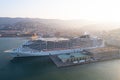 Drone shot of the nautical and a cruise ship MSC Fantasia anchored in seaport Trieste, Italy Royalty Free Stock Photo