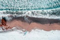 Drone shot, photography on beach with sand, snow and waves in Lofoten, Norway