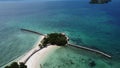 Drone shot of the sapphire water around Little Liguid Island Buenavista Resort on a sunny day