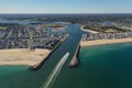 Drone shot of a ship passing through the Manasquan Inlet in New Jersey on a bright sunny day Royalty Free Stock Photo