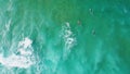 Drone shot surfers swimming in ocean water waiting waves. Extreme active hobby Royalty Free Stock Photo