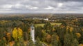 Drone shot of the Suur Munamagi Tower in Haanja, Estonia, surrounded by autumn forest