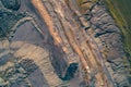 Abstract aerial view of massive, fan-shaped industrial waste piles and layered, terraced mine earth, creating a dark Royalty Free Stock Photo