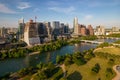 Drone shot of TX skyline with waterfront, greenery and blue cloudy sky in Austin city