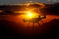 Drone silhouette flying over line of mountains. Sunset Royalty Free Stock Photo