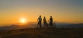 DRONE: Mountain bikers stop and observe the sunset after a downhill adventure. Royalty Free Stock Photo