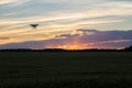 Drone silhouetted against orange sunset Royalty Free Stock Photo