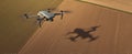 The drone soaring over agricultural fields casting a distinctive shadow..AI generated image Royalty Free Stock Photo