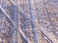 Aerial shot of tractor tracks in a field.