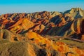 DRONE: Stunning aerial view of unique striped mountains in China at sunset.