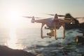 The drone in the sunset sky. ocean wave mountains Close up of quadrocopter outdoors. concept for film maker wedding videography