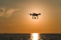 The drone in the sunset sky. ocean wave mountains Close up of quadrocopter outdoors. concept for film maker wedding videography