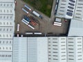 Drone top down view of a large warehousing facility showing partial solar panels on the roof tops.