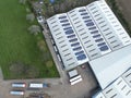 Drone top down view of a large warehousing facility showing partial solar panels.