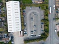 Drone top down view of a warehouse facility showing the large adjacent carpark.