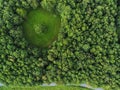 Drone top view on a park scene, Small creek and walking path, Round shape meadow in a forest Royalty Free Stock Photo