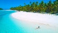 DRONE: Tourist girl in bikini sunbathing on the beautiful exotic island beach. Royalty Free Stock Photo