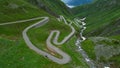 DRONE: Tourists on fun road trip across Switzerland drive along Gotthardpass. Royalty Free Stock Photo