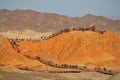 DRONE: Tourists move along the walkways leading up a hill in Danxia landform.