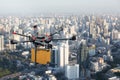 Drone transport flying with cardboard box above city Royalty Free Stock Photo