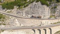 DRONE: Truck carrying heavy wood cargo driving on a mountain pass in Italy. Royalty Free Stock Photo