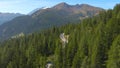 DRONE: Cars driving on a winding road, surrounded by green Italian landscape. Royalty Free Stock Photo