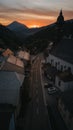 Drone vertical shot of a small road in a rural village in the Austrian mountains during sunset Royalty Free Stock Photo