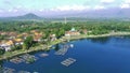 drone video of a scenic village nestled on the shores of a Ranu Pakis lake.