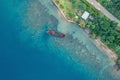 Drone view of abandoned broken sunken old ship that ran aground. Tropical coast of Sanma, Vanuatu