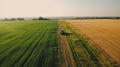 Drone view of agriculture farming, fields stretching a symphony of green crops, farmer and tractor farming Photography from top