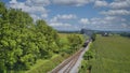 Drone View of an Antique Steam Engine, Approaching, Blowing Steam and Traveling Along the Countryside Royalty Free Stock Photo