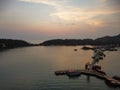 Drone view of the Bang Bao Pier in Koh Chang, Thailand at sunset with forests in the background