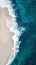 Drone view of the beach with waves splashing at the coast