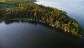 Drone view of boats docked near the forested coast of Lake Niegocin, Masuria, Poland