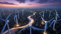 Drone view capturing dynamic winding paths through a densely arranged wind turbine forest at dusk Royalty Free Stock Photo