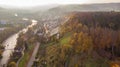 Drone view of city Brugg south-west and Umiken with Aare river, residential districts, bridge and old mill, famous train viaduct