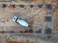 Drone view of a concrete truck and workers on a construction site