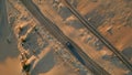Drone view desert highway running along sandy terrain summer. Transport riding