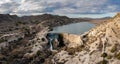 Drone view of the Elche Reservoir and dam wall with waterfall and surrounding semi-desert landscape Royalty Free Stock Photo