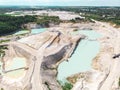 Drone view on a flooded kaolin quarry with turquoise water and white shore. Aerial shot of a kaolin pit flooded with water